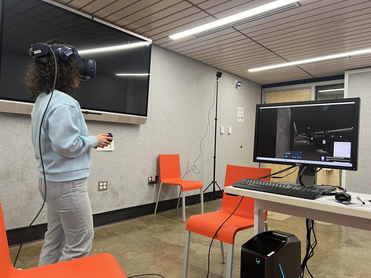 Graduate student Marayam Kazemidemneh gives a demonstration of how her virtual reality-based lighting experiment works.