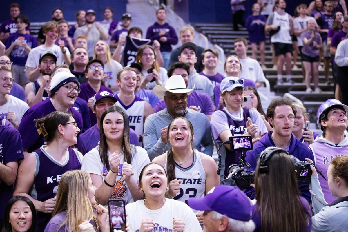 Head coach Jerome Tang celebrates in the student section after the game against West Virginia University on Feb. 26, 2024 in Bramlage Coliseum. The Wildcats beat the Mountaineers in overtime 94-90, a necessary win for K-States March Madness hopes.