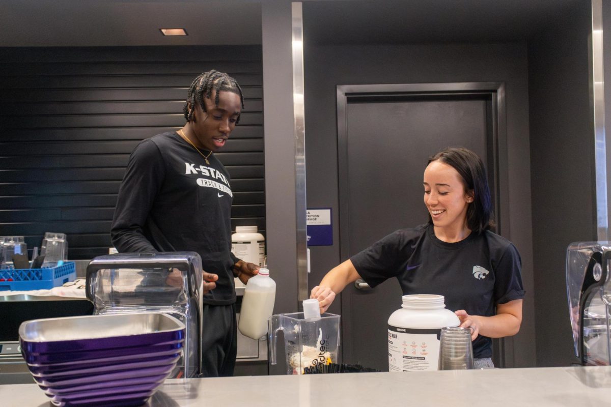 K-State Athletics sports nutritionist LaReine Schock-Leonard works with junior track and field athlete James Ezeonu on a healthy protein smoothie. Schock-Leonard works with many athletes at K-State keeping student athletes prepared for their busy schedules. 