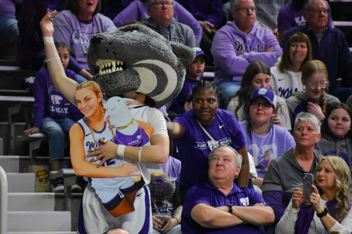 Willie the Wildcats holds a cutout of guard Gabby Gregory and Gap Goat during senior night.