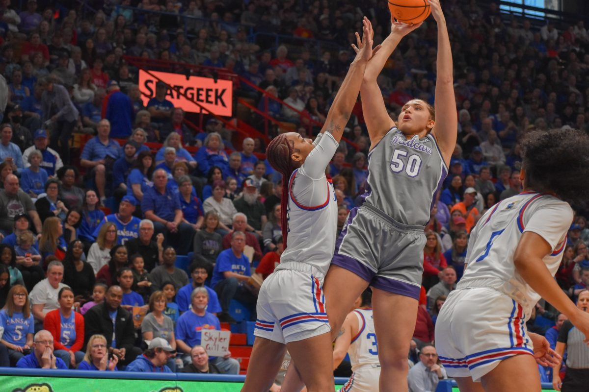 Center Ayoka Lee goes for a jumper against Kansas center Taiyanna Jackson. Because of Jacksons defense, Lee shot 7-21 against the Jayhawks in K-States 55-58 loss.