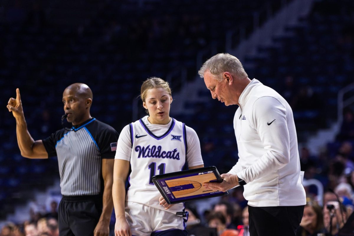 Head coach Jeff Mittie shows guard Taryn Sides a play during the West Virginia game on Feb. 21. Sides will be a key player in K-States Iowa State matchup on Feb. 28.
