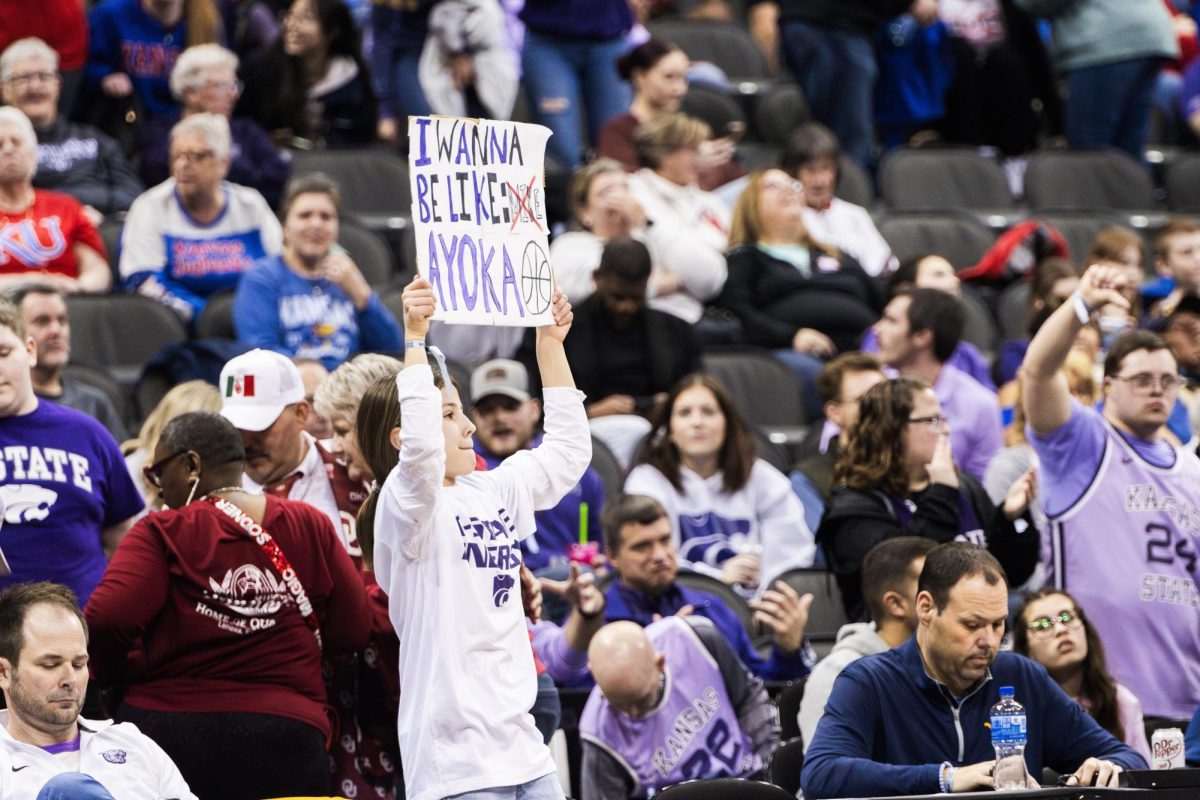 A young K-State fan holds up a sign, showing support for center Ayoka Lee at the most attended session since 2013. The Wildcats beat  West Virginia 65-62 in the quarterfinals of the Big 12 tournament located at the T-Mobile Center in Kansas City, Missouri on March 9.