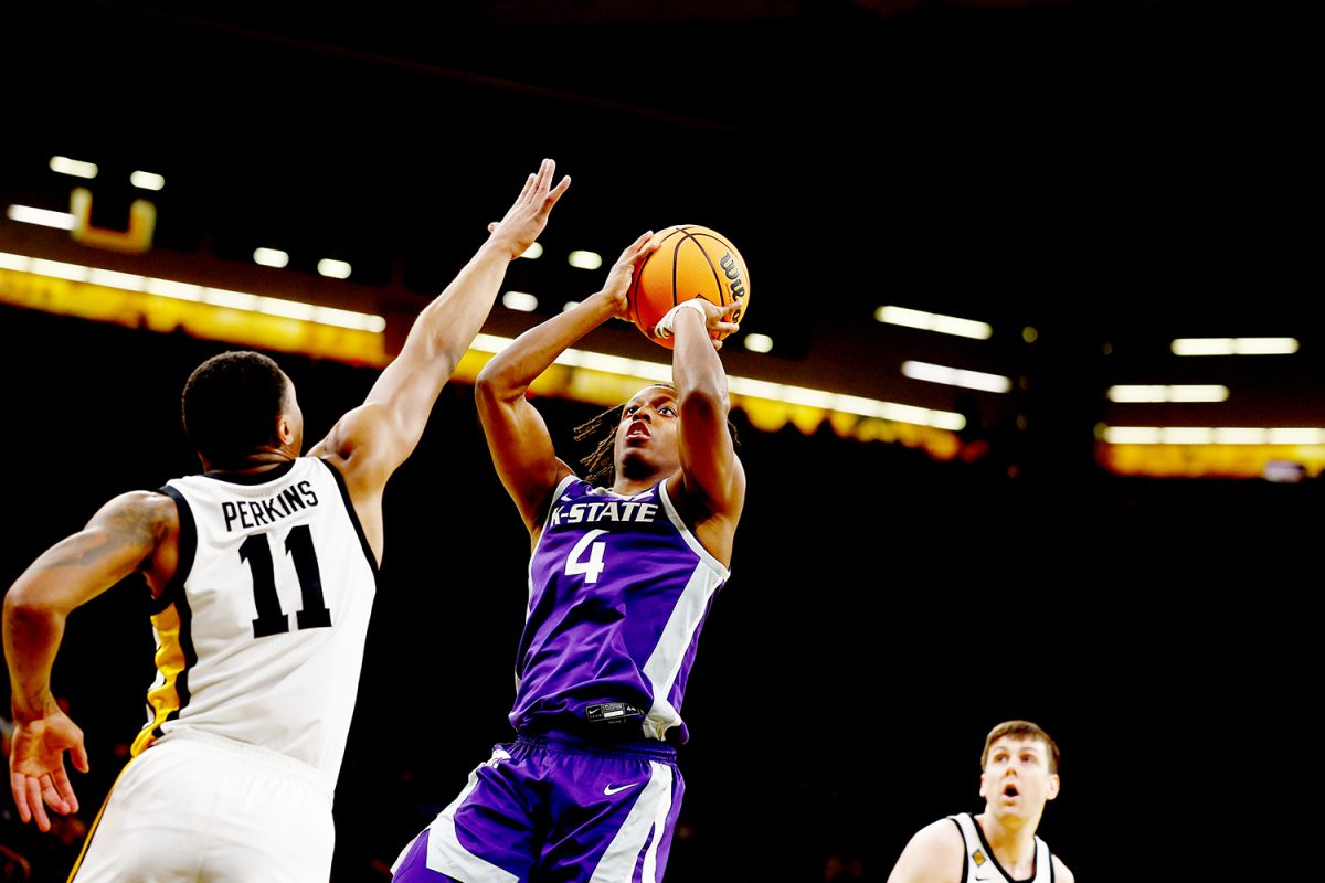 Guard Dai Dai Ames shoots a fadeaway against Iowa guard Tony Perkins. K-State fell to the Hawkeyes 91-82 in the first round of the NIT. (Photo courtesy of K-State Athletics)