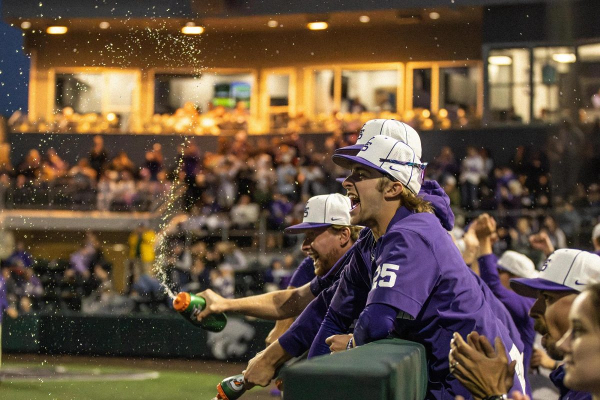 Freshman Rohan Putz celebrates in the dugout after a big play from K-State. The Wildcats created play-after-play, defeating Texas 14-6 to open the three-game series.