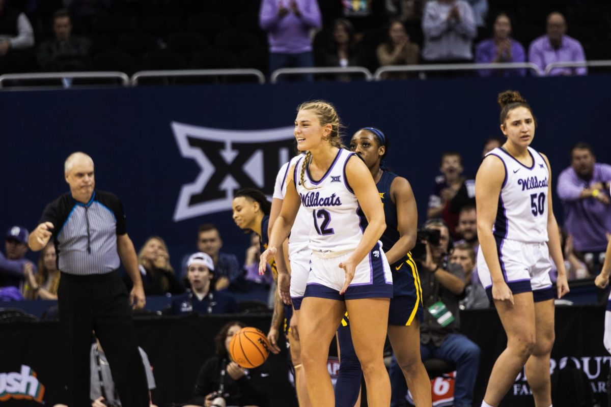 Guard Gabby Gregory celebrates with a smile and clap after sealing the K-State win. The Wildcats beat West Virginia 65-62 in the quarterfinals of the Big 12 tournament located at the T-Mobile Center in Kansas City, Missouri on March 9.