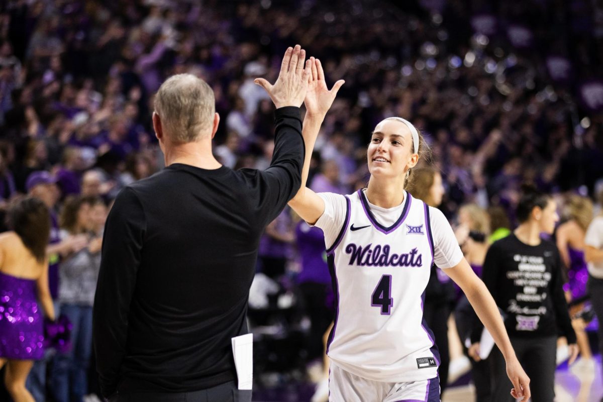Guard+Serena+Sundell+and+head+coach+Jeff+Mittie+high-five+to+celebrate+the+69-68+win+after+the+game+against+Oklahoma+State+on+Feb.+10.+Sundell+hit+the+game-winning+layup+with+23+seconds+left+to+secure+the+win.+