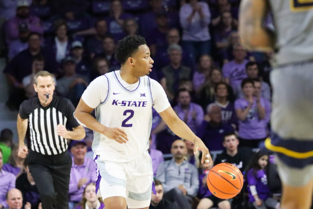 Guard Tylor Perry dribbles up the court against West Virginia on Feb. 26 in Bramlage Coliseum. Perry will play a crucial role in the Big 12 tournament, starting with Texas on Wednesday.
