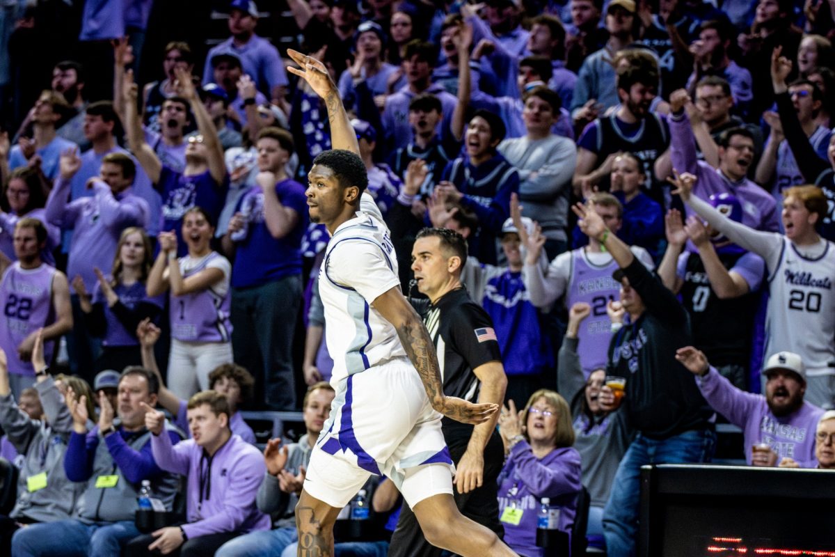 Guard Cam Carter puts his hand up in the 3 sign after hitting a 3-pointer against Iowa State. Carter went 3-8 on 3s in the 65-58 upset, finishing the game with 21 points.