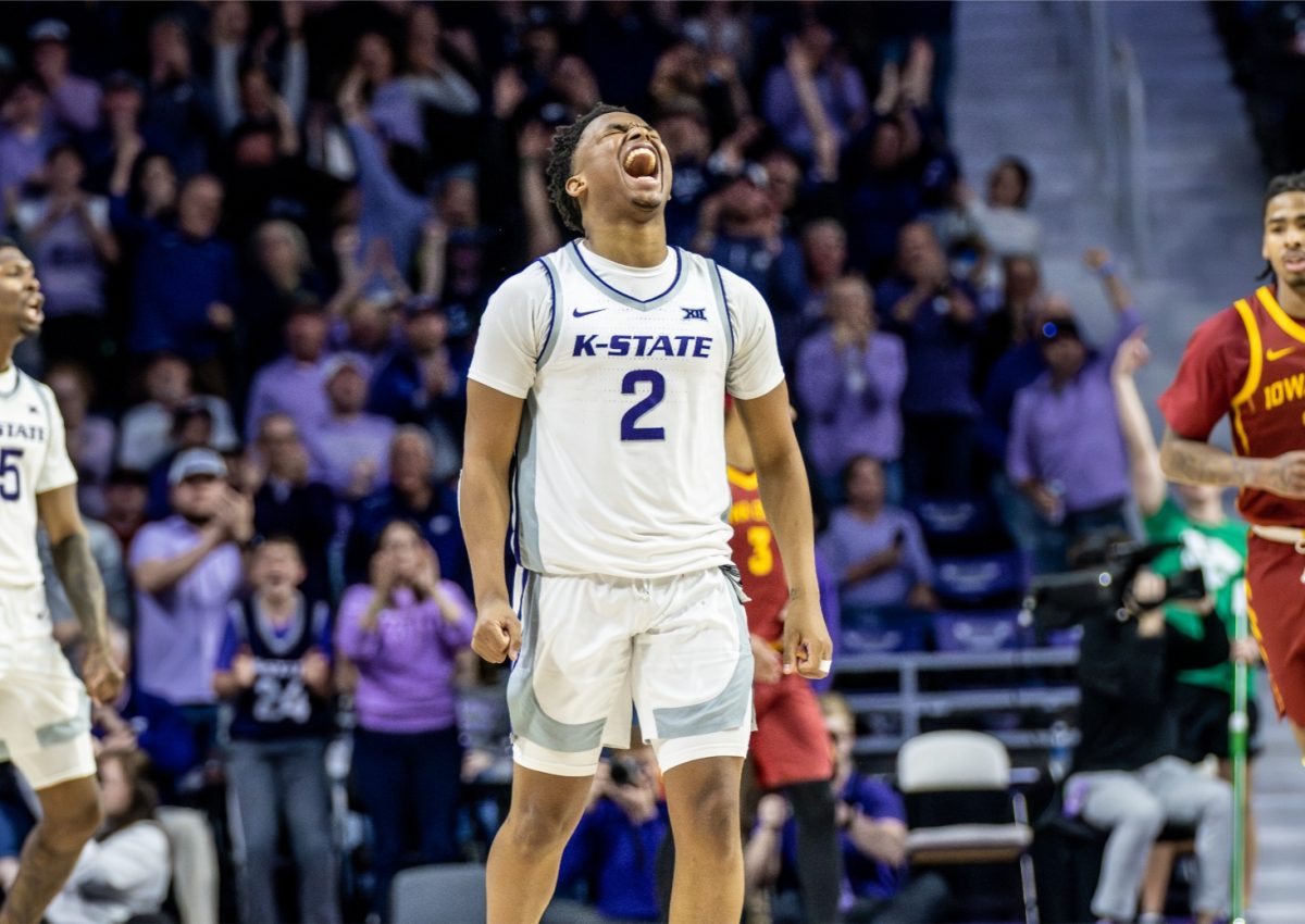 Guard Tylor Perry yells with excitement against Iowa State in his final regular season game. Perry had five assists, six points and three rebounds in the 65-58 upset.