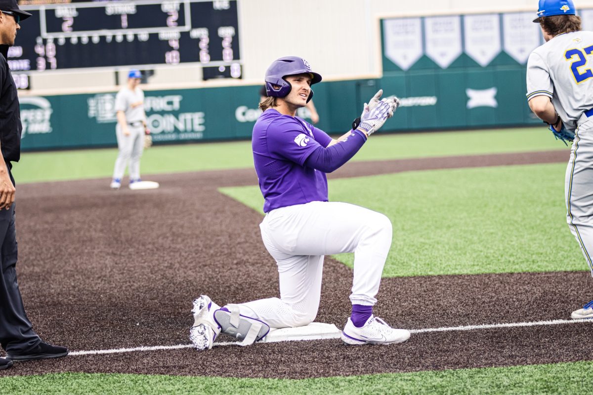 Left fielder Chuck Ingram claps after safely landing on third base. Ingram had three runs and three RBI on three hits in the blowout 16-5 Wildcat win over South Dakota State.