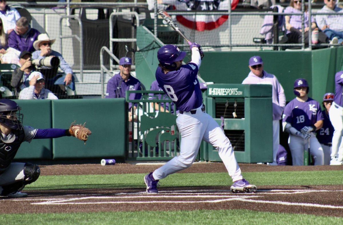 Right fielder Nick English swings and makes contact with the ball in a 5-4 Wildcat win against Holy Cross on Feb. 25. Against Wichita State, English put up three RBI and one run as K-State won 8-6 in Wichita.