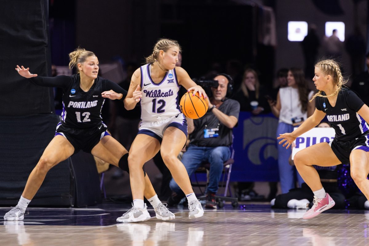 Ball in hand, guard Gabby Gregory turns away from the basket against Portland in K-States 78-65 round of 64 victory over the Pilots. Gregory led scoring with a season-high 22 points.