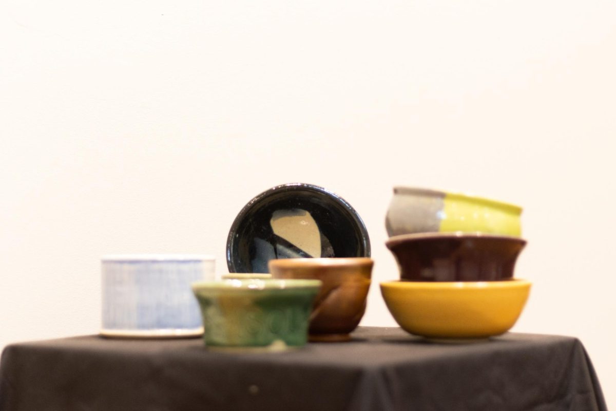 Manhattan Arts Center’s studio manager Justice Catron along with students created bowls for the first MAC & Cheese Festival taking place April 13. Those who purchase a bowl for $25 have the chance to try all of the different styles of mac and cheese with proceeds going to Common Table.