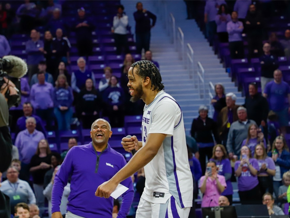 Center Will McNair Jr. cracks a joke into the mic, cracking up head coach Jerome Tang during the teams senior day celebration.