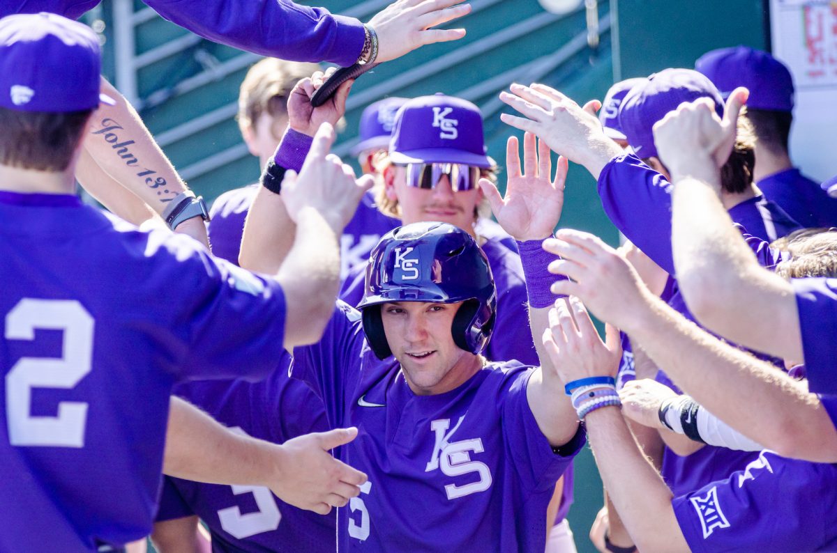 Outfielder Brenden Jones high-fives his teammates after scoring a run for the Wildcats. The Wildcats beat Holy Cross 5-4 on Feb. 24 as Jones scored two runs with two hits and three walks. 