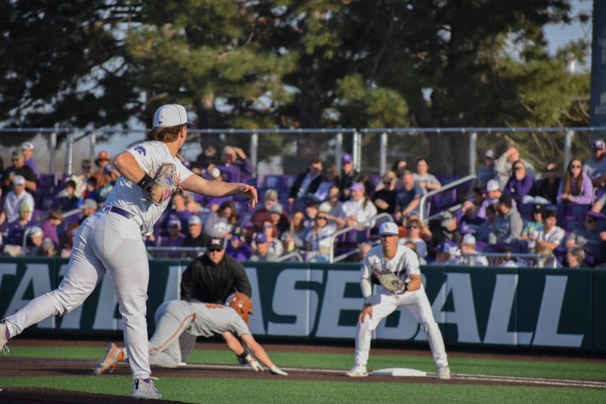 K-State pitcher Jacob Frost performs a pickoff attempt to first baseman David Bishop. K-State fell to Texas 21-11 in a historic 32-run game Saturday, tying the series 1-1.
