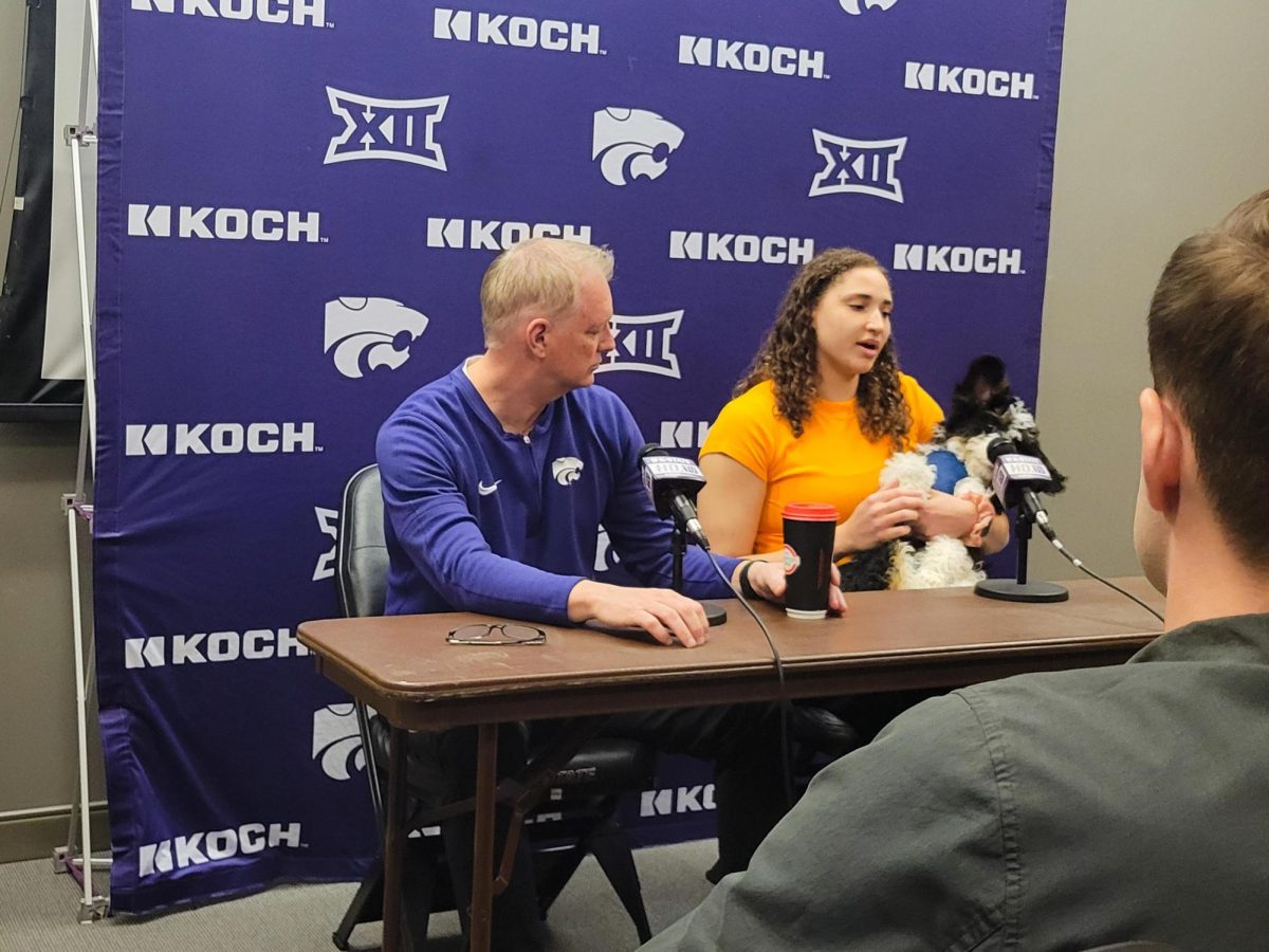 Head coach Jeff Mittie and center Ayoka Lee are joined by new team-dog Bram at a press conference. Lee and Mittie discussed Lees process to return to K-State for one more season.