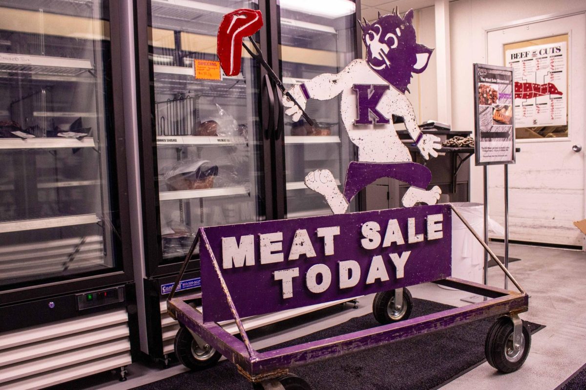 A mascot mark Willie with a prong fork of steak sits outside Weber Hall Fridays for the weekly meat sale.