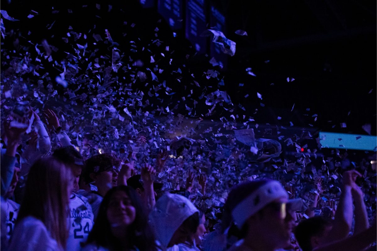 The student section throws newspaper as the starting lineup is announced before K-States game against Villanova on Dec. 5, 2023. K-State won 72-71 in overtime in Bramlage Coliseum.
