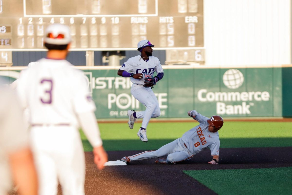 Shortstop Kaelen Culpepper leaps over a Texas baserunner to attempt a double play on Friday, March 29. The Wildcats loss the game 21-11 as the 32 runs set a record for the highest score game in a matchup between the two schools in their head-to-head history.