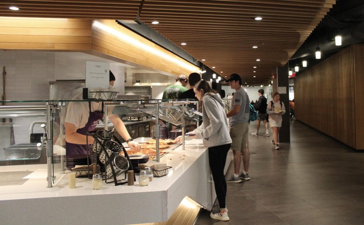Students line up to get pizza at the dining center which is a part of the Derby dorms complex. It is open from 7 a.m. to 7 p.m. and offers a wide variety of food for students.