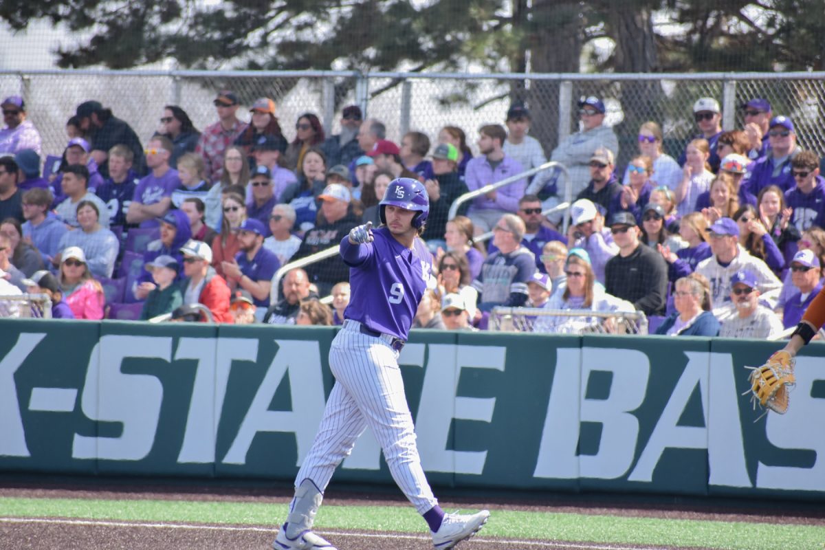 Left fielder Chuck Ingram points out after making it to first base in Game 3 against Texas. Ingram took the lead for the Wildcats against UCF but ultimately loss 7-4.