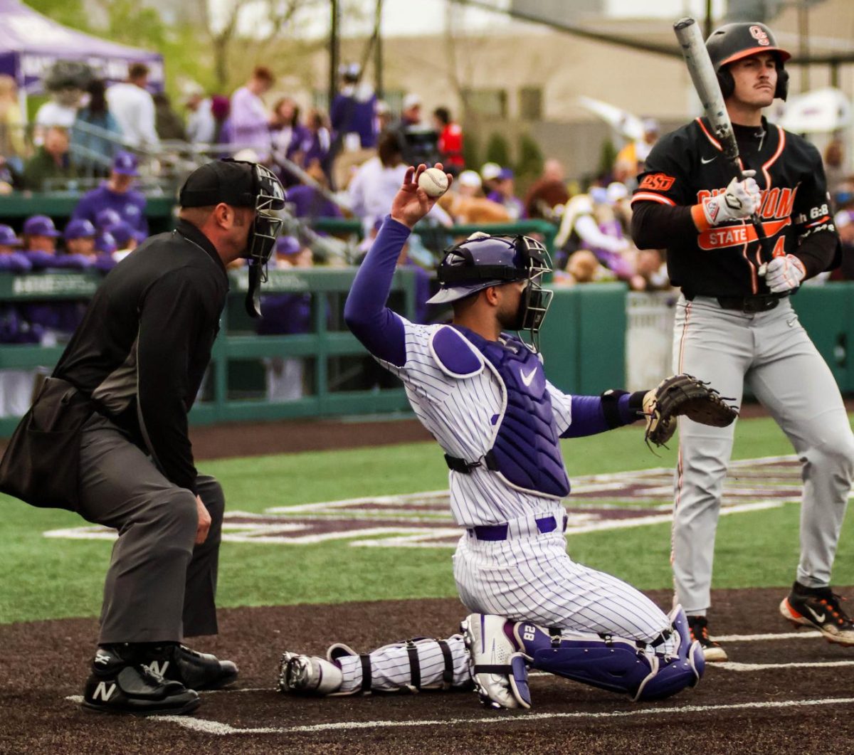 Catcher Raphael Pelletier throws the ball back against Oklahoma State. K-State won the series 2-1, the last series win the Wildcats have gained before playing Kansas.