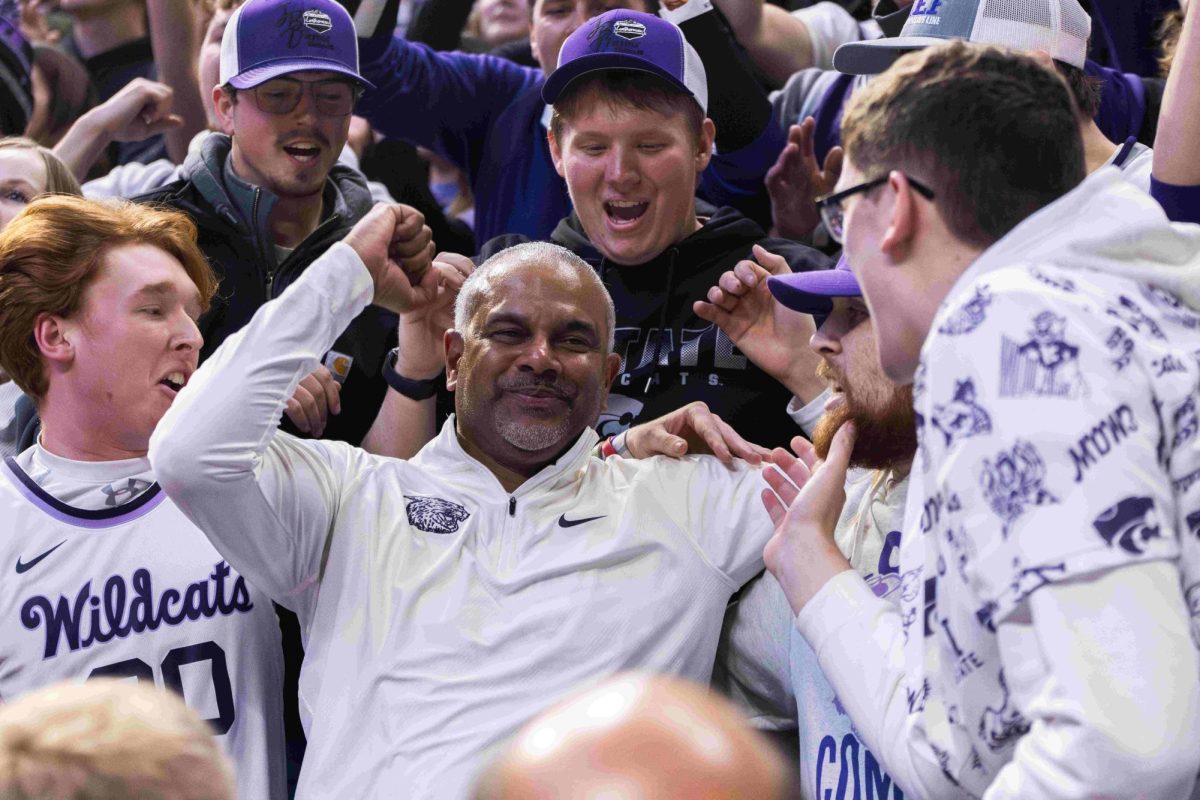 K-State men's basketball head coach Jerome Tang sings the K-State alma mater with students following the Wildcat win over the Baylor Bears. The Wildcats beat the Bears 68-64 in overtime on Jan. 16 at Bramlage Coliseum, putting the Wildcats 10-0 in overtime under coach Tang.