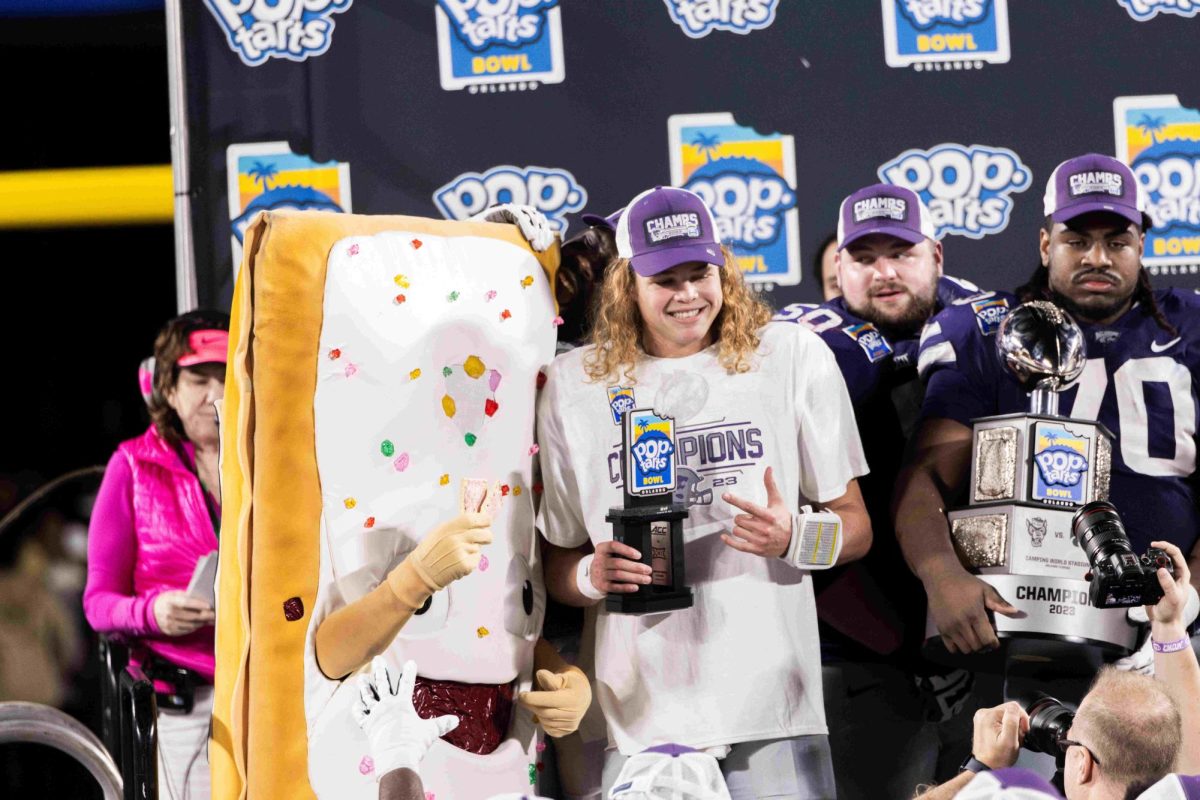 Freshman quarterback Avery Johnson poses with the Pop-Tarts Bowl mascot, Strawberry, as the 2023 Pop-Tarts Bowl MVP. K-State won the Pop-Tarts Bowl on Dec. 28, 2023 with a final score of 28-19 against North Carolina State. 