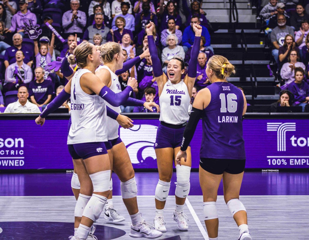 Senior Izzi Szulczewski throws her hands up in excitement after scoring a point. The Wildcats fell to the Sooners 0-3 on Sept. 22 at Morgan Family Arena.