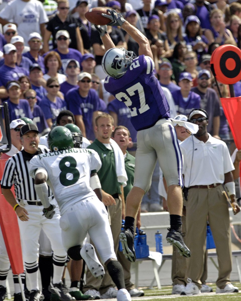 Kansas State wide receiver Jordy Nelson (27) goes up high to pull in the pass along the sideline over North Texas defensive back T.J. Covington (8) in the first quarter. Kansas State defeated the Mean Green of North Texas 54-7 at KSU Stadium in Manhattan, Kansas on September 24, 2005. (Photo courtesy of K-State Athletics)