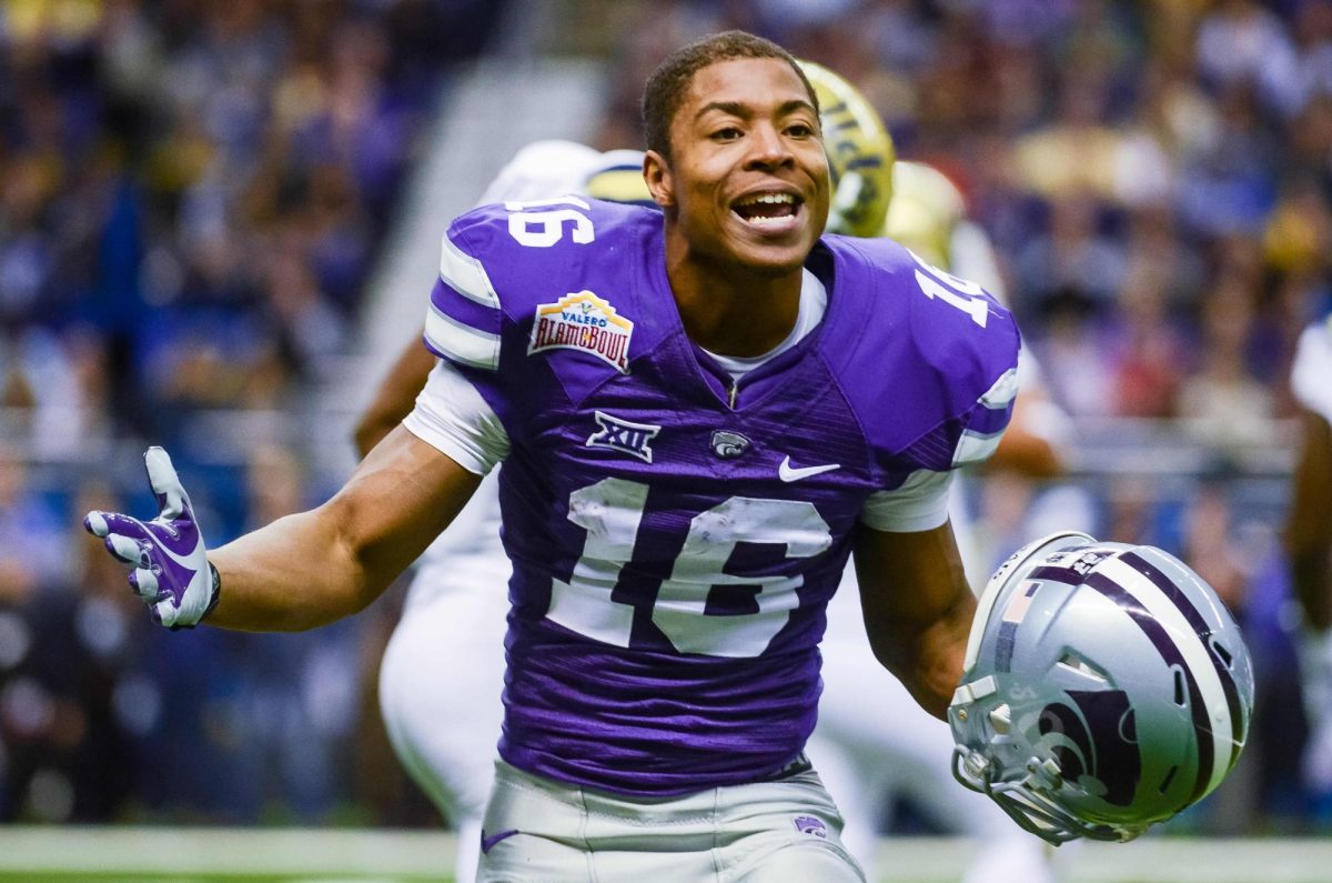 Senior wide receiver Tyler Lockett raises his arms in frustration after being tackled by a horde of UCLA defenders following an eleven yard reception during the first quarter of No. 11 K-State's 35-40 loss to No. 14 UCLA in the Valero Alamo Bowl January 2, 2015, in the Alamodome in San Antonio, Texas. 