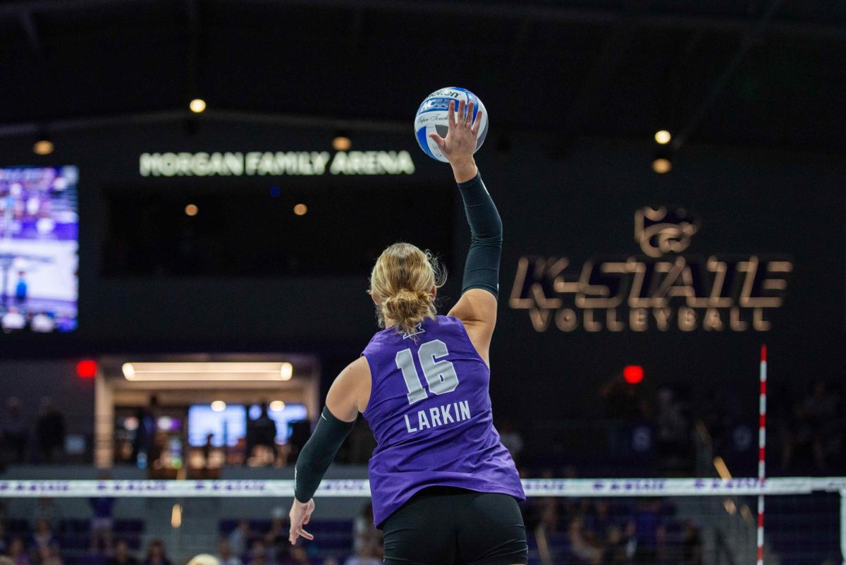 K-State libero Ella Larkin serves up the ball in a matchup against Houston on Sept. 25. The senior transfer leads the Wildcats defensively with a team-high 4.45 digs.