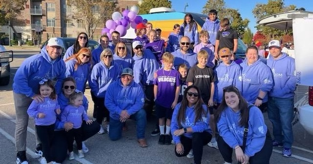 Freedom Behavioral Health Solutions staff preparing to walk in the K-State homecoming parade. (Photo courtesy of Curtis Yonke)