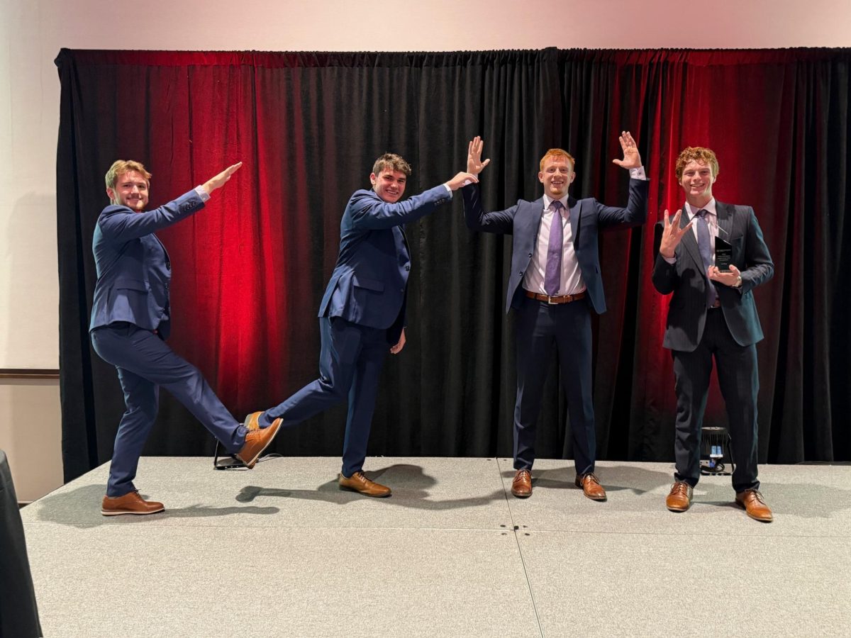 Sophomores Logan Forssberg, Quinton Pfaff, Caden Parker and Chase Ruda pose with their first place plaque after winning the 2024 Collins Aerospace Case competition in Cedar Rapids, Iowa on Oct. 18. “We were all very good friends going into this, which I think provided us a great advantage,” Forssberg said. (Photo courtesy of Brandon Savage)
