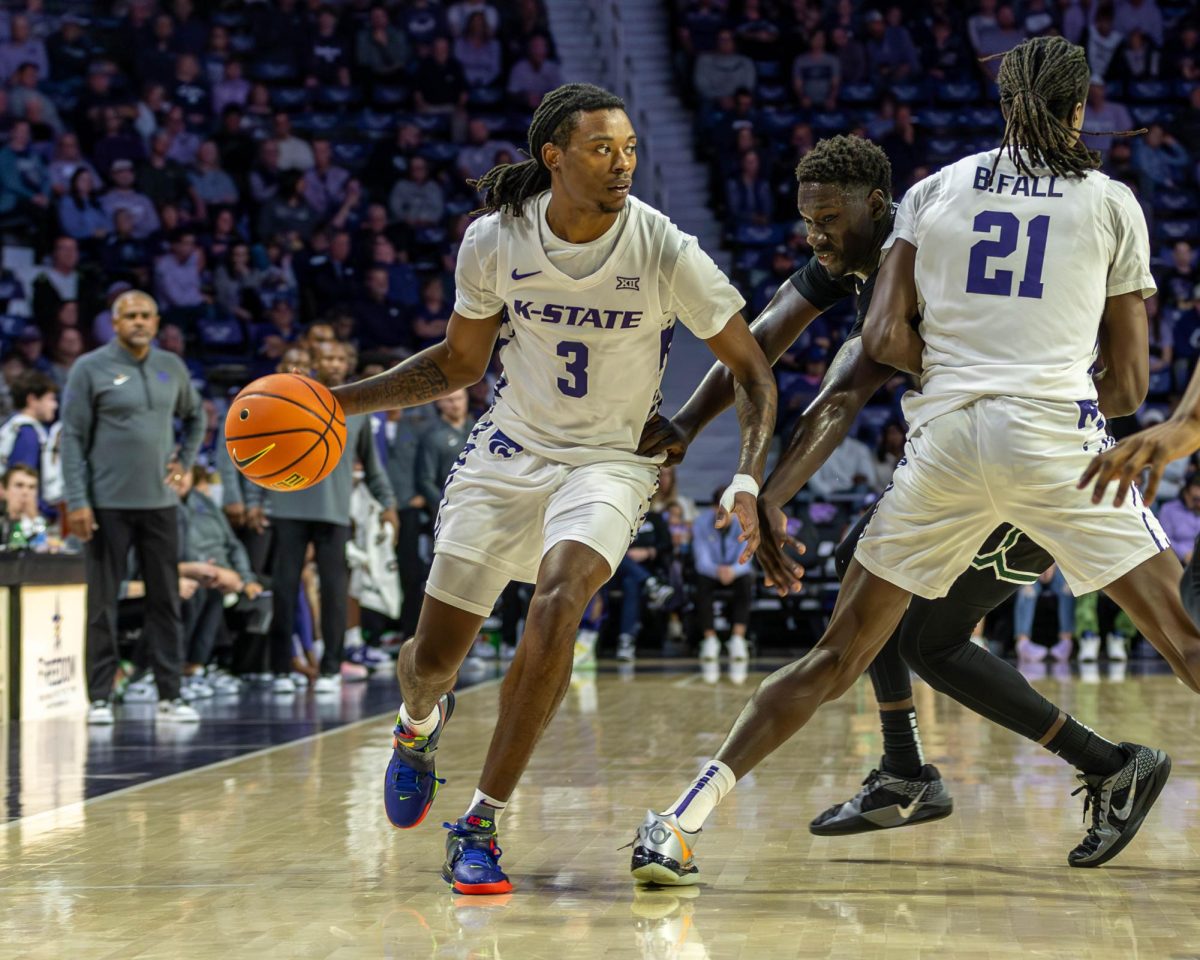 K-State guard CJ Jones dribbles against a defender. The Wildcats won against the Cleveland State Vikings 77-64 on Nov. 9 at Bramlage Coliseum.