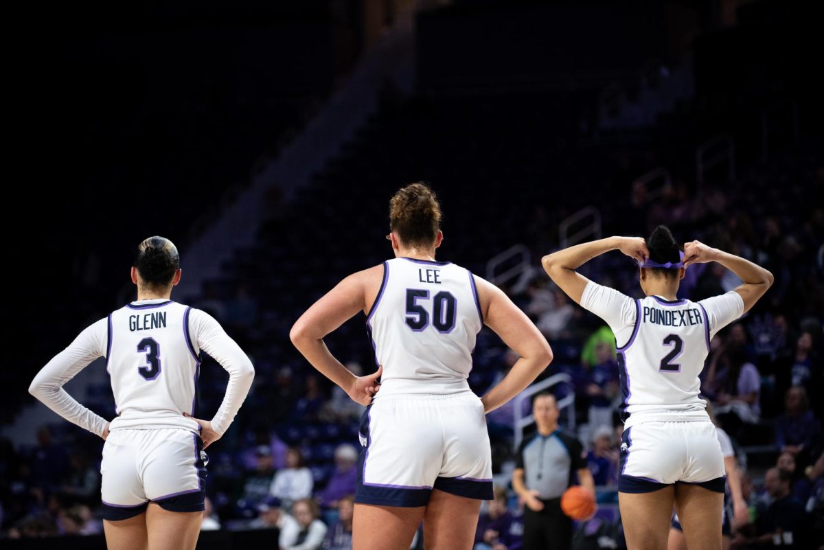 Kansas State center Ayoka Lee stands  beside teammates Jaelyn Glenn and Temira Poindexter during No. 13 K-State's win over New Mexico State on Dec. 19. K-State finished non-con play 12-1.