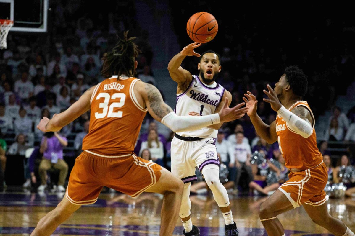 Without looking, senior guard Markquis Nowell blindly passes the ball to a teammate through Longhorn defenders. Nowell signed with the Toronto Raptors' G-League affiliate after college before joining the Houston Rocket's G-League squad this year.