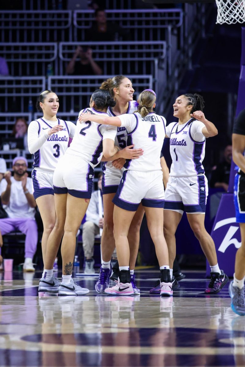 No. 13 K-State rushes to celebrate star center Ayoka Lee's accomplishment of becoming the Wildcats' all-time leading scorer. K-State won 90-43 against Eastern Illinois on Dec. 3.