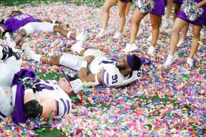 Felix Anudike-Uzomah makes confetti angels on the field after winning the game. K-State beat TCU 31-28 in overtime to win the Big 12 Championship at AT&T Stadium on December 3, 2022. 