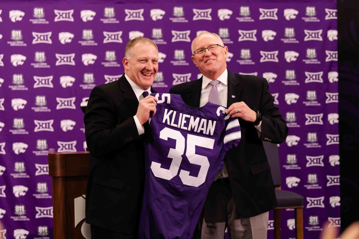 Head coach Chris Klieman (left) and K-State athletic director Gene Taylor (right) hold up a jersey with Klieman's name on it as he was welcomed to Manhattan on Wednesday, Dec. 12, 2018, as the next football coach. Klieman marked the first of many successful hirings for Taylor during his tenure at K-State. 