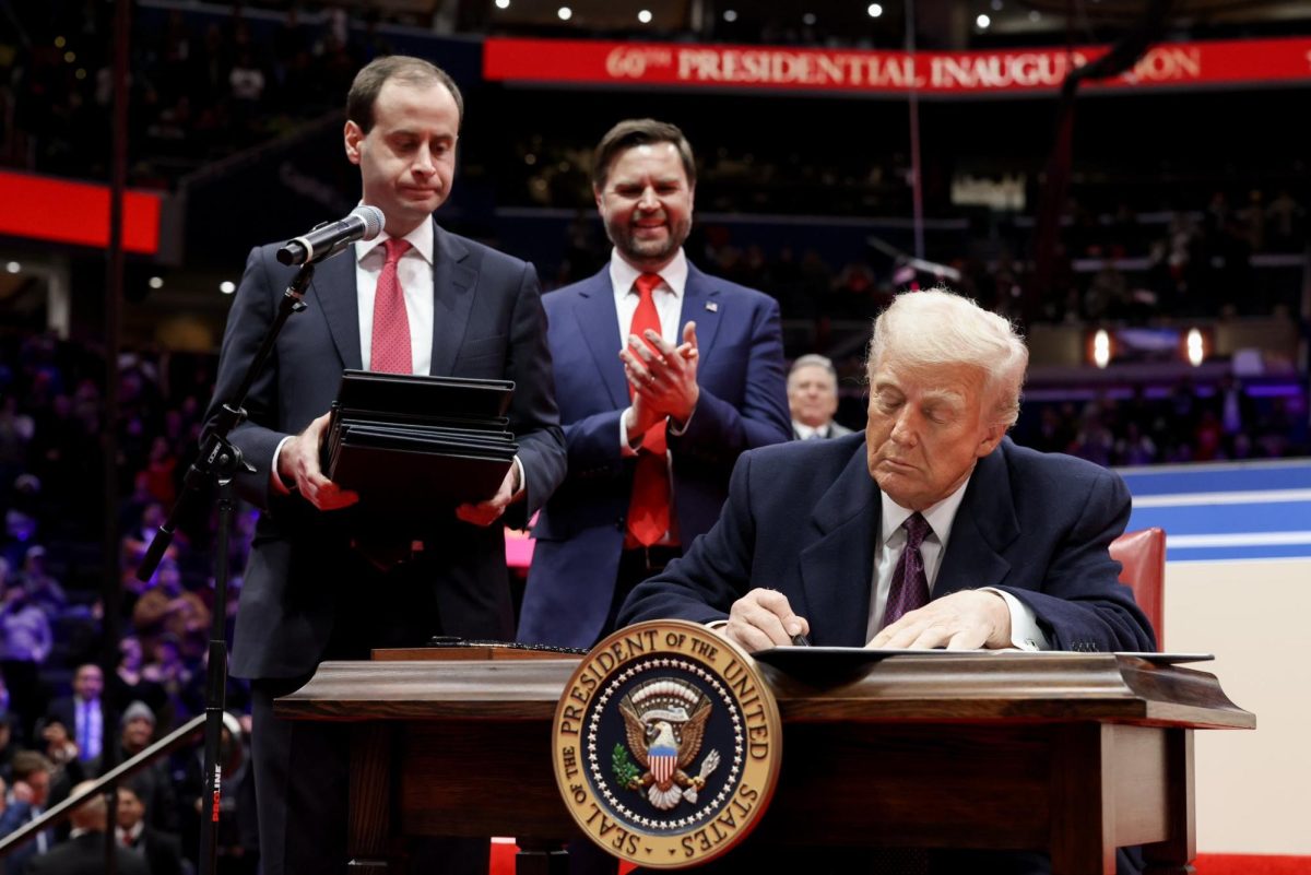 Trump signs an executive order in Capital One Arena on Jan. 20, 2025. Trump signed 35 orders in his first week. (Photo courtesy of Wikimedia Commons)