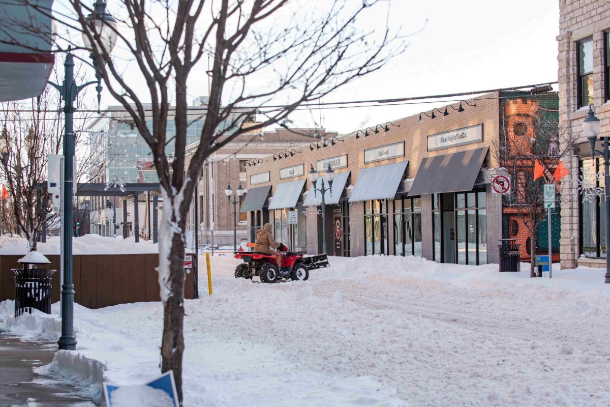 A man on a four wheeler attempts to clear out the entrances to businesses on 4th Street following the snowstorm that occured on January 5th. Quad bikes and side-by-sides were frequent on the roads as people worked to clear over a foot of snow from the Manhattan area.