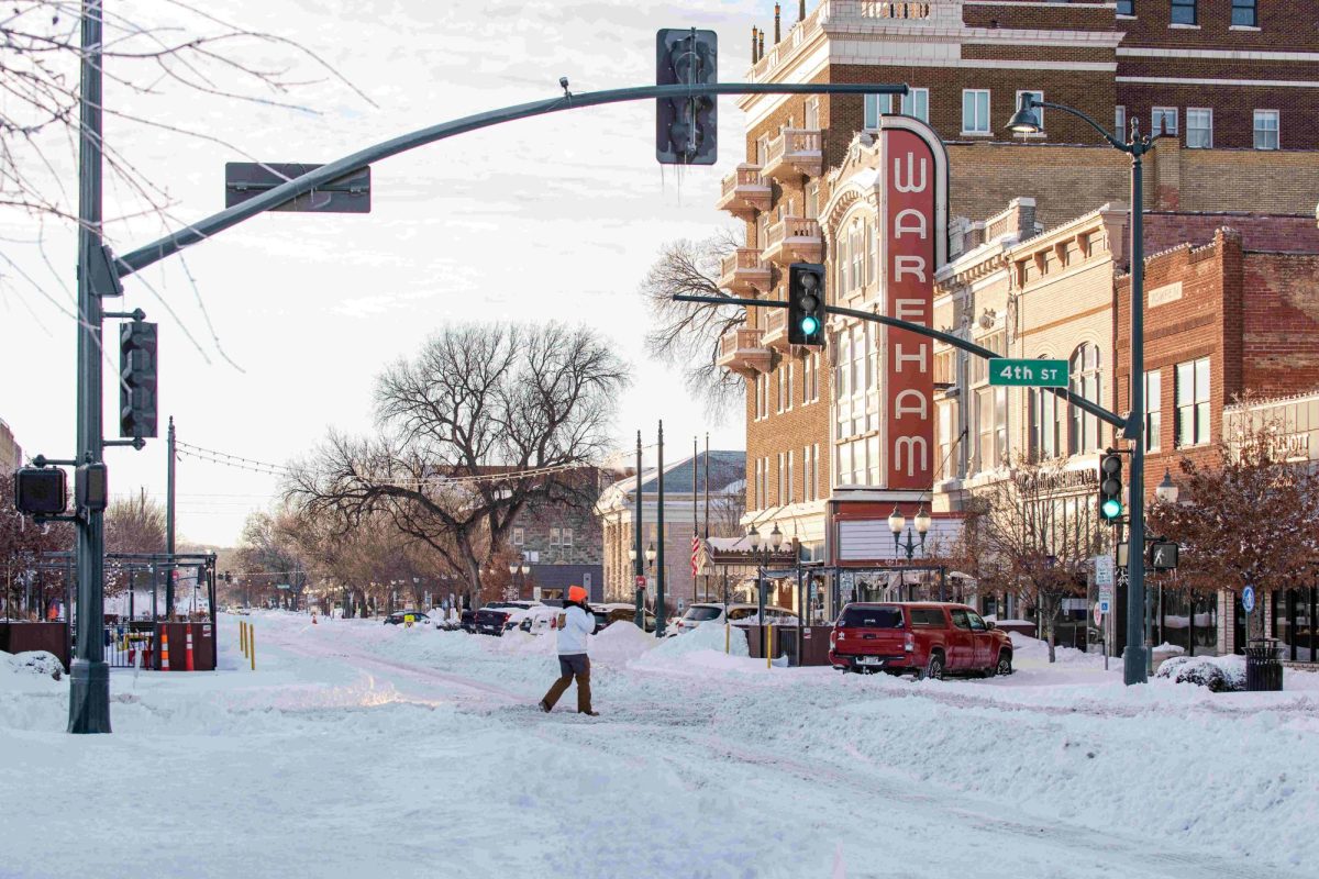 A pedestrian makes his way across a snowpacked Poyntz Avenue on January 6, 2025.