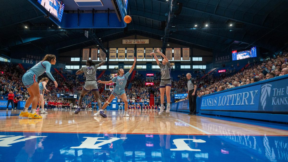 Kansas State guard Taryn Sides serves up a 3-pointer at Allen Fieldhouse in Lawrence on Sunday. No. 11 K-State won the Sunflower Showdown 91-64.