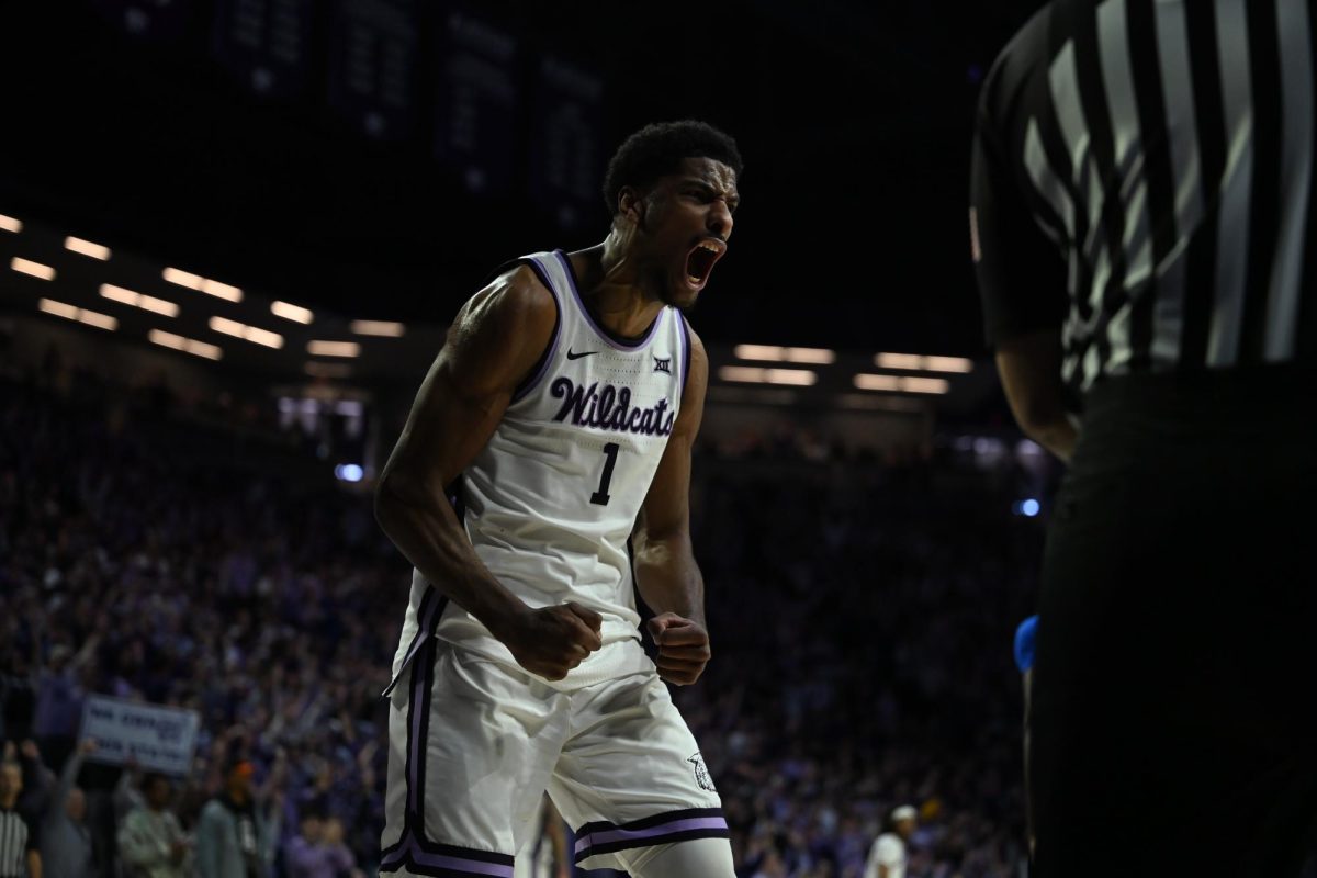 Senior center David N'Guessan flexes after a bucket against No. 16 Kansas as K-State won 81-73 at Bramlage on Feb. 8. N'Guessan scored 20 points as he and head coach Jerome Tang won three straight Sunflower Showdown at home. 