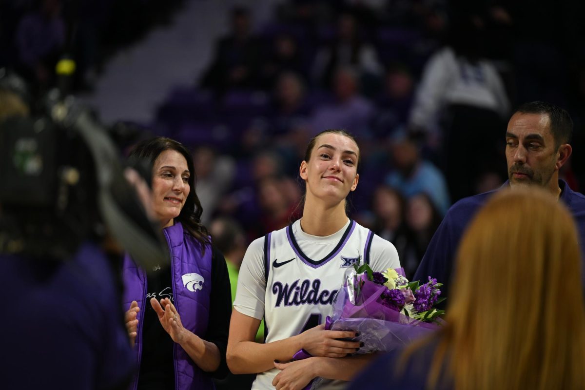 Guard Serena Sundell holds her post-game flowers during K-State's Senior Day celebration. Sundell set the program record for assists in a single game with 15 as the No. 12 Wildcats beat rival Kansas 90-60 on Saturday.