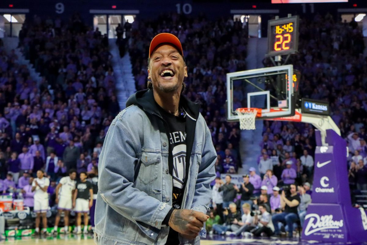 Former K-State men’s basketball star Michael Beasley smiles on the sideline at Bramlage Coliseum on Saturday. Beasley, a former No. 2 overall NBA Draft pick, returned to Manhattan for the Wildcats’ Sunflower Showdown win over rival Kansas. He was arrested Sunday morning at the Manhattan airport for marijuana possession.