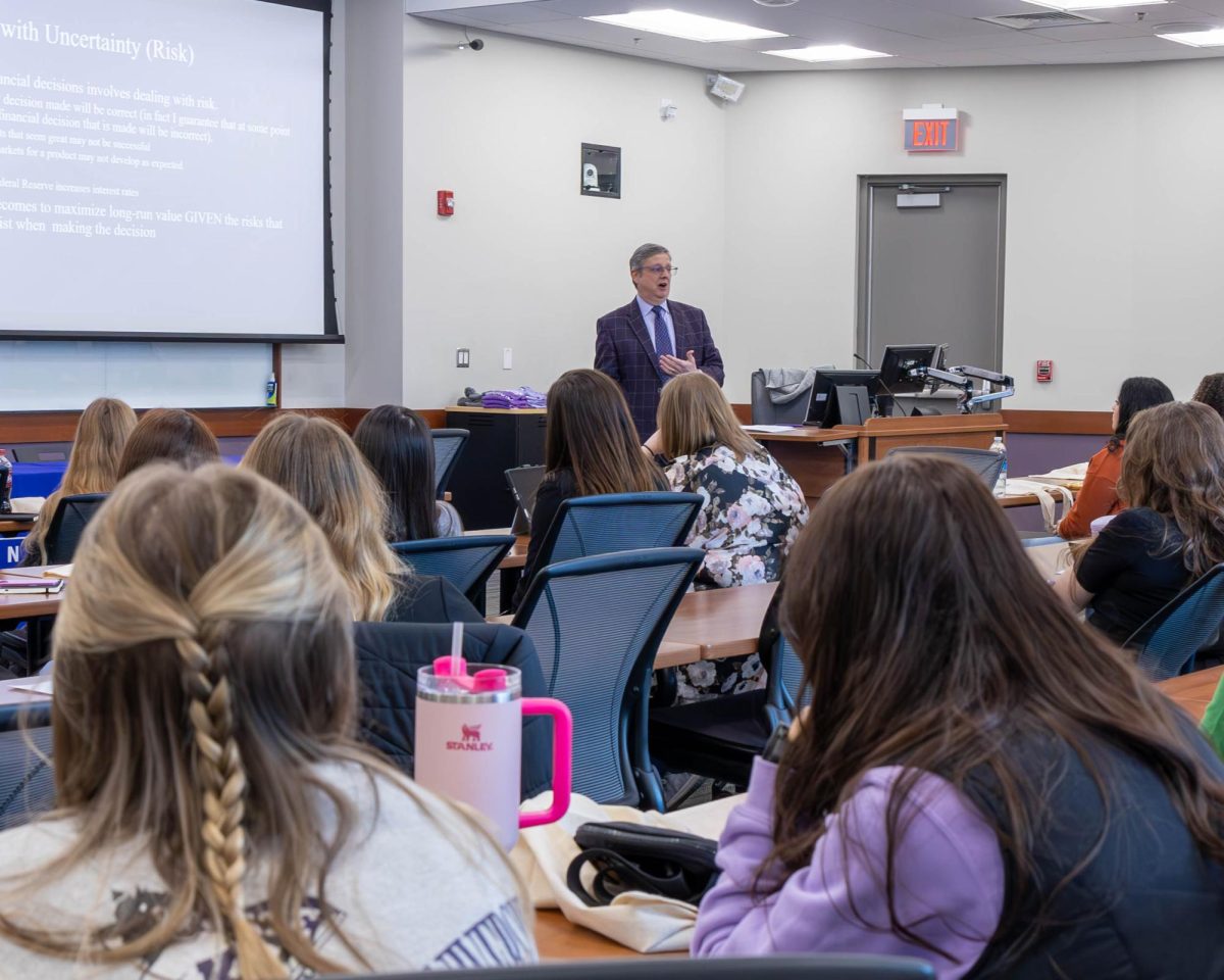 High School students listen speakers discuss women in finance on Women in Finance Day at the Business Building.